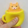 Игрушка антистресс "Кошка в чашке" желтая